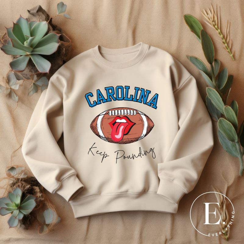 Support the Carolina Panthers in style with our modern and trendy sweatshirt featuring the team's name and powerful teams slogan, "Keep Pounding."  On a sand colored sweatshirt. 