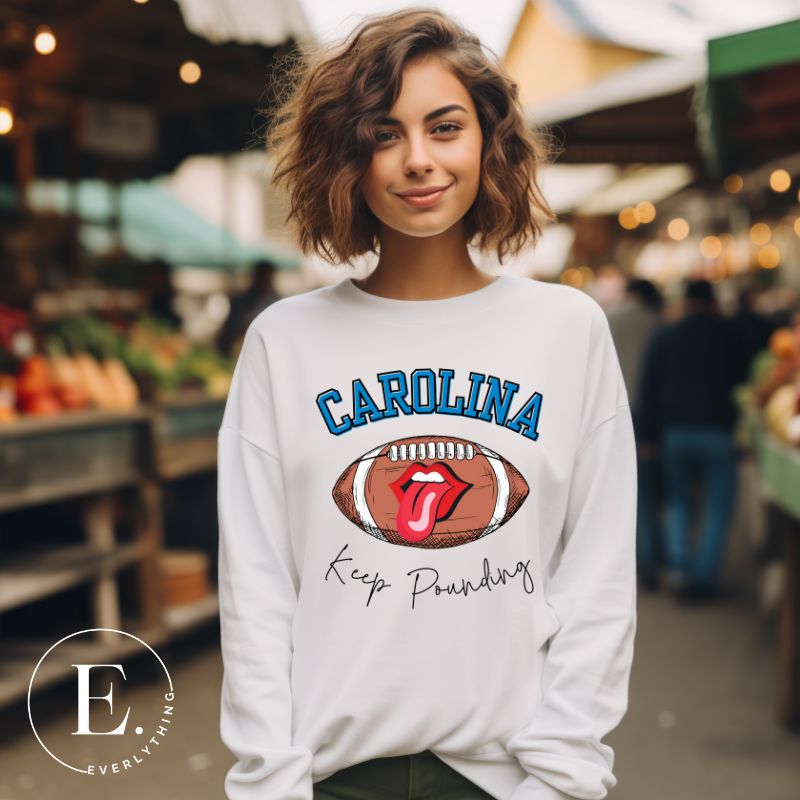 Support the Carolina Panthers in style with our modern and trendy sweatshirt featuring the team's name and powerful teams slogan, "Keep Pounding." On a white sweatshirt. 