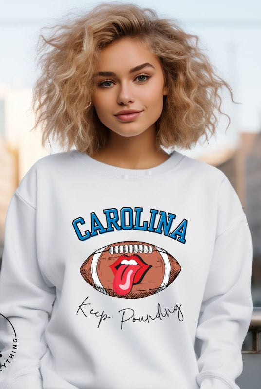 Support the Carolina Panthers in style with our modern and trendy sweatshirt featuring the team's name and powerful teams slogan, "Keep Pounding."  ON a white sweatshirt. 