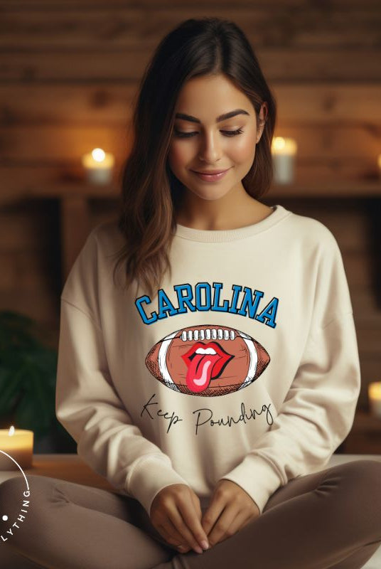 Support the Carolina Panthers in style with our modern and trendy sweatshirt featuring the team's name and powerful teams slogan, "Keep Pounding."  On a sand colored sweatshirt. 