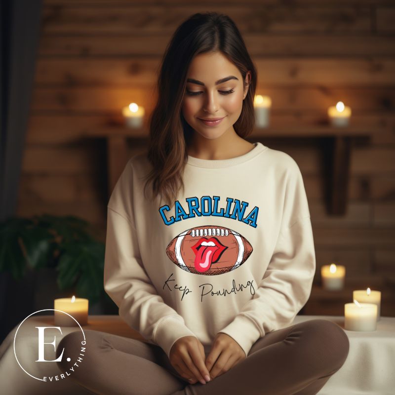 Support the Carolina Panthers in style with our modern and trendy sweatshirt featuring the team's name and powerful teams slogan, "Keep Pounding."  On a sand colored sweatshirt. 