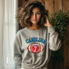 Support the Carolina Panthers in style with our modern and trendy sweatshirt featuring the team's name and powerful teams slogan, "Keep Pounding."  On a grey sweatshirt. 