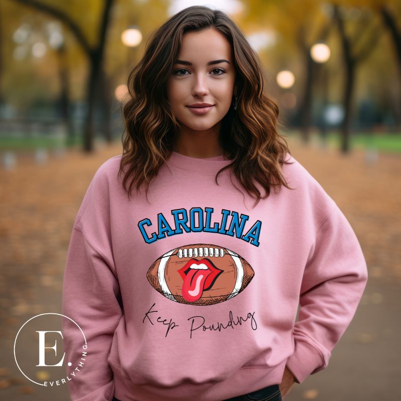 Support the Carolina Panthers in style with our modern and trendy sweatshirt featuring the team's name and powerful teams slogan, "Keep Pounding."  On a pink sweatshirt. 