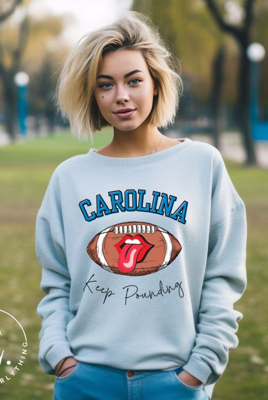 Support the Carolina Panthers in style with our modern and trendy sweatshirt featuring the team's name and powerful teams slogan, "Keep Pounding."  On a blue sweatshirt. 