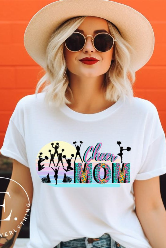 Get your cheer on with our stylish cheer mom shirt. Perfect for proud moms supporting their cheering stars. Made with love, this shirt combines comfort and fashion, letting you show off your team spirit. Join the cheer squad and cheer your heart out in style on a white shirt. 