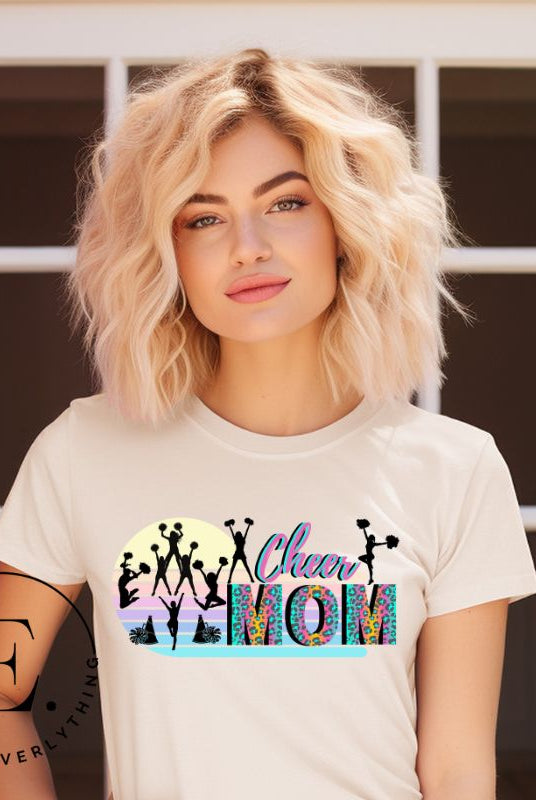 Get your cheer on with our stylish cheer mom shirt. Perfect for proud moms supporting their cheering stars. Made with love, this shirt combines comfort and fashion, letting you show off your team spirit. Join the cheer squad and cheer your heart out in style on a soft cream shirt. 