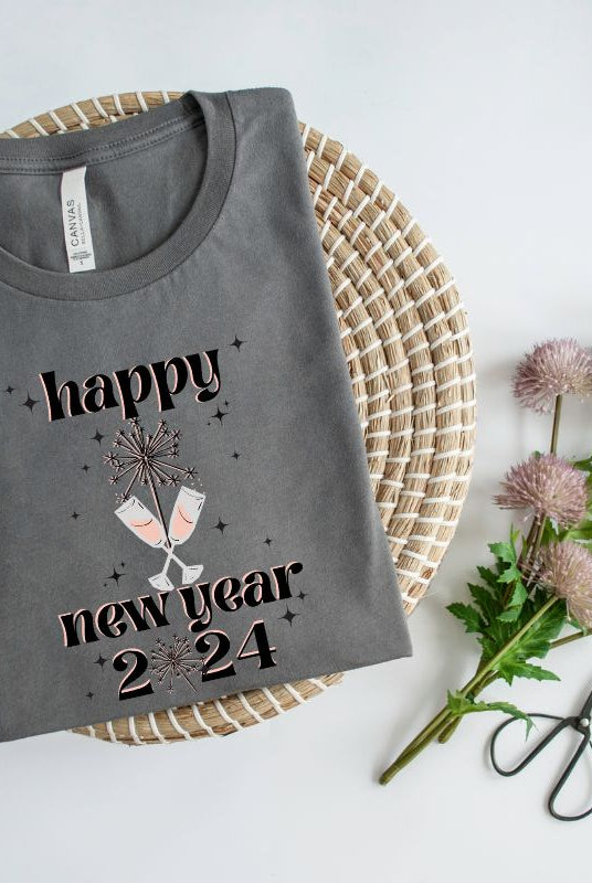 Welcome 2024 in sparkling style with our 'Happy New Year 2024' shirt. Adorned with two clinking champagne glasses amidst fireworks on a dark grey shirt. 