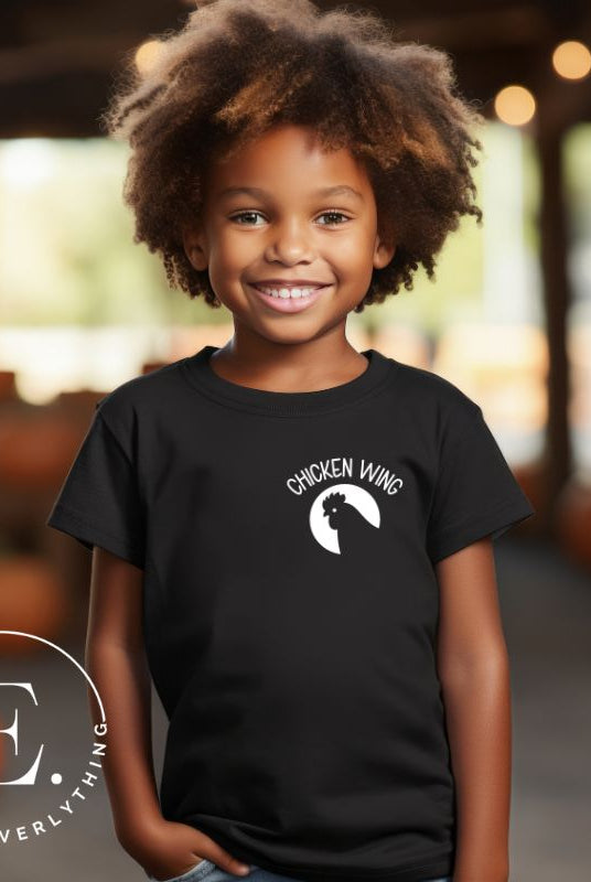 Introducing our fun and funky kids shirt with a twist! This vibrant tee features an adorable pocket design that proudly declares "Chicken Wing.' But that's not all! On the back, you'll find the catchy lyrics to the beloved song "Chicken Wing, Chicken Wing" with delightful array of images that support the songs lyrics