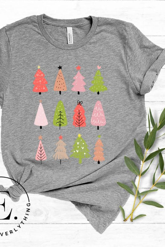 Upgrade your holiday fashion with our contemporary Christmas shirt. The shirt features three rows of multiple different modern Christmas trees in each row, creating a trendy and charming design on a grey shirt.