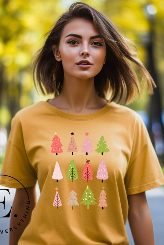 Upgrade your holiday fashion with our contemporary Christmas shirt. The shirt features three rows of multiple different modern Christmas trees in each row, creating a trendy and charming design on a yellow shirt. 