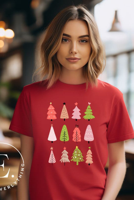 Upgrade your holiday fashion with our contemporary Christmas shirt. The shirt features three rows of multiple different modern Christmas trees in each row, creating a trendy and charming design on a red shirt. 