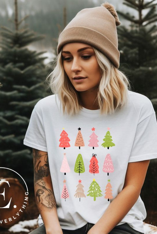 Upgrade your holiday fashion with our contemporary Christmas shirt. The shirt features three rows of multiple different modern Christmas trees in each row, creating a trendy and charming design on a white shirt. 