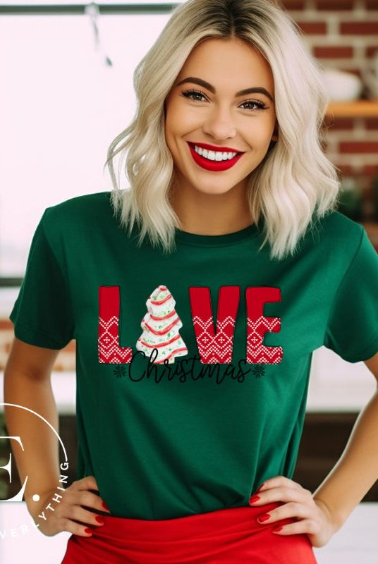Spread love and joy this holiday season with our Christmas shirt featuring the classic Christmas tree cake, which is incorporated into the word "Love" on a green colored shirt.