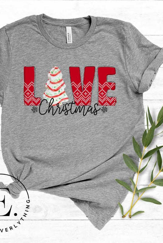 Capture the sweetness of the season with our downloadable Christmas PNG sublimation t-shirt design! The word 'love' is beautifully adorned with a classic Christmas tree cake, adding a delicious touch to your holiday style on a grey colored shirt. 