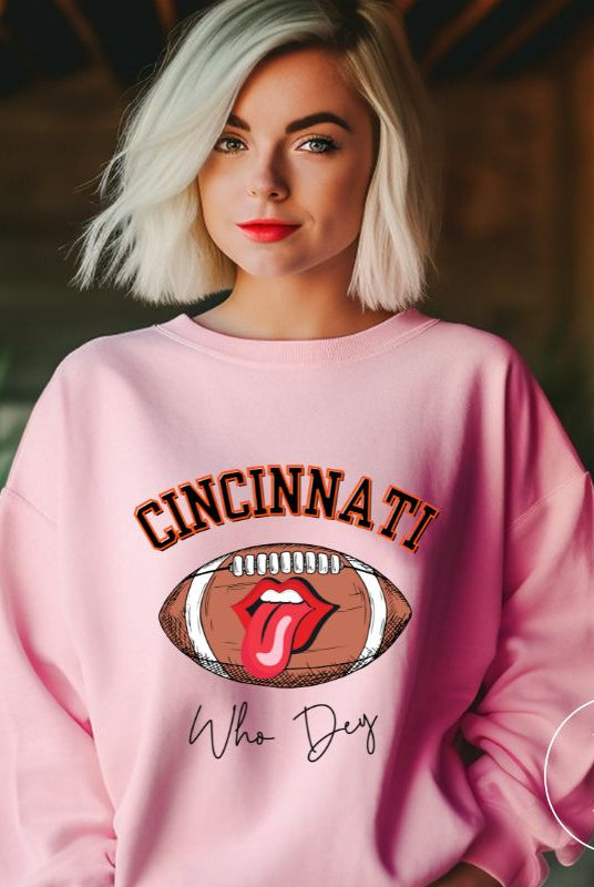 Gear up and show your support for the Cincinnati Bengals with our premium sweatshirt featuring the team's name and rallying slogan, "Who Dey." On a pink sweatshirt. 