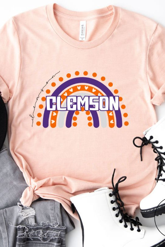 Celebrate your love for Clemson University with our colorful college t-shirt that showcases the beautiful Clemson colors that creates a stunning rainbow backdrop, with the schools name atop a peach shirt.