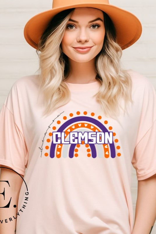 Celebrate your love for Clemson University with our colorful college t-shirt that showcases the beautiful Clemson colors that creates a stunning rainbow backdrop, with the schools name atop a peach shirt. 