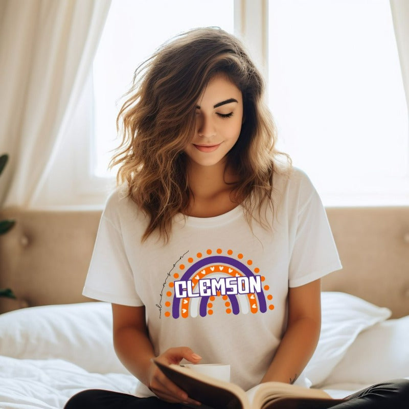 Bella + Canvas 3001 unisex shirt featuring a colorful rainbow design with the word "Clemson" in the center, representing Clemson University on a white graphic tee.