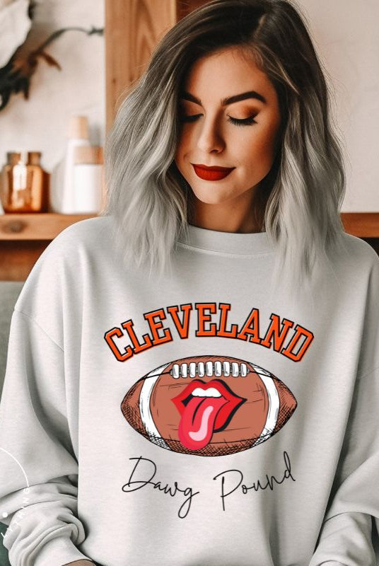Show your Cleveland Browns pride with our exclusive sweatshirt featuring the team's name and iconic slogan, "Dawg Pound." On a grey sweatshirt. 
