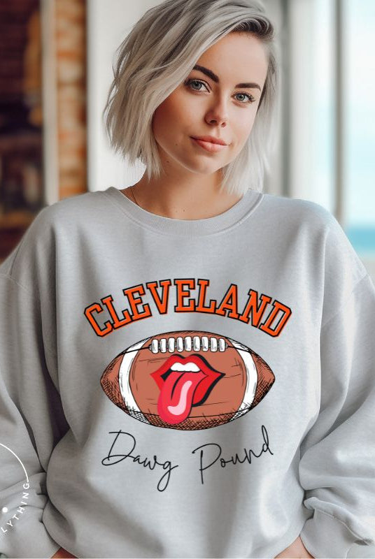 Show your Cleveland Browns pride with our exclusive sweatshirt featuring the team's name and iconic slogan, "Dawg Pound." On a grey sweatshirt. 