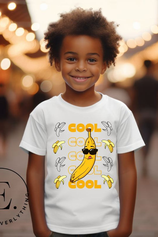 Our kids' shirt is the perfect mix of fun and style, sure to make your little one stand out. It features the word "cool" repeated four times in four rows, topped off with a banana wearing sunglasses on a white shirt. 