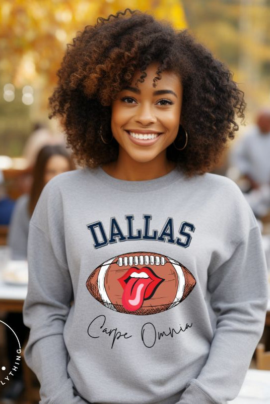 Embrace your Dallas Cowboys pride with our premium sweatshirt showcasing the team's name and empowering slogan, "Crape Omnia." On a grey sweatshirt. 