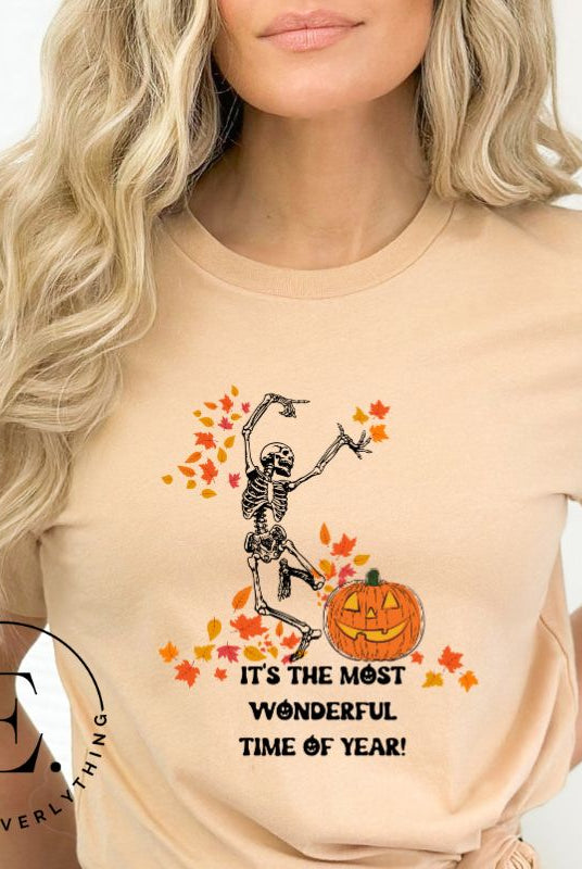 Get into the spirit of fall with our Dancing Skeleton T-shirt. This playful shirt features a whimsical skeleton surrounded by falling leaves, on a tan shirt. 