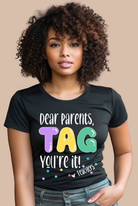 Humorous graphic tee with the saying 'Dear Parents TAG You're it' - a great addition to teacher shirts and teacher gifts. Black graphic tees.