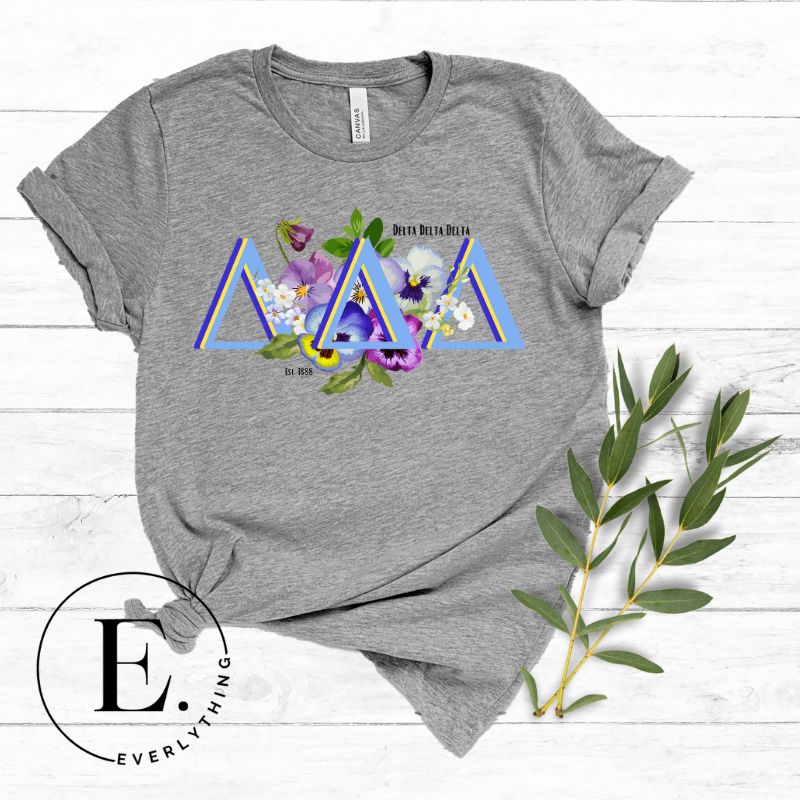 Flaunt your Delta Delta Delta sisterhood with our downloadable PNG sublimation t-shirt design! Featuring the sorority letters and the beautiful pansy on a grey shirt. 