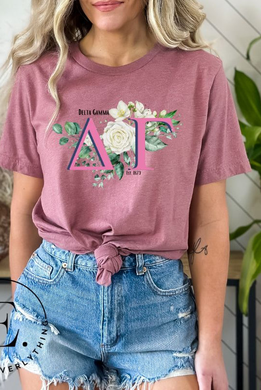Display your Delta Gamma pride with our downloadable PNG Sublimation t-shirt design! Featuring the sorority letters and the exquisite cream-colored rose on a pink shirt. 