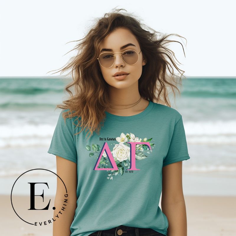 Display your Delta Gamma pride with our downloadable PNG Sublimation t-shirt design! Featuring the sorority letters and the exquisite cream-colored rose on teal shirt. 