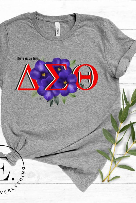 Show off your Delta Sigma Theta sisterhood with our exclusive sorority t-shirt design! The t-shirt features the sorority's letters along with the vibrant African violet, symbolizing empowerment, strength, and courage on a grey shirt. 