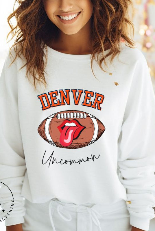 Get ready to show your support for the Denver Broncos in style with our exclusive sweatshirt featuring the team's iconic name and their slogan "uncommon." On a white sweatshirt. 