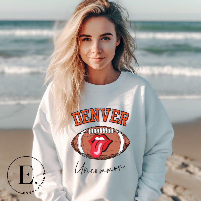 Get ready to show your support for the Denver Broncos in style with our exclusive sweatshirt featuring the team's iconic name and their slogan "uncommon." On a white sweatshirt. 