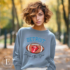 Get ready to show your Detroit Lions pride with this stylish sweatshirt featuring a football and playful lips and tongue design. Complete with the team's slogan "Defend the Den" and the iconic Detroit wordmark, this cozy blue sweatshirt. 