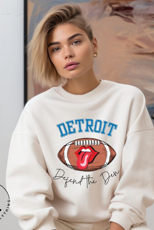 Get ready to show your Detroit Lions pride with this stylish sweatshirt featuring a football and playful lips and tongue design. Complete with the team's slogan "Defend the Den" and the iconic Detroit wordmark, this cozy white sweatshirt. 