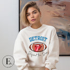 Get ready to show your Detroit Lions pride with this stylish sweatshirt featuring a football and playful lips and tongue design. Complete with the team's slogan "Defend the Den" and the iconic Detroit wordmark, this cozy white sweatshirt. 