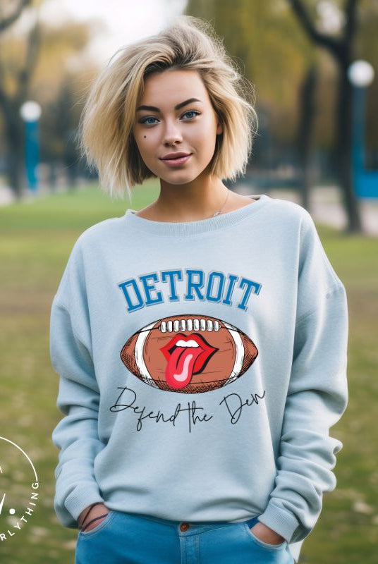 Get ready to show your Detroit Lions pride with this stylish sweatshirt featuring a football and playful lips and tongue design. Complete with the team's slogan "Defend the Den" and the iconic Detroit wordmark, this cozy  blue sweatshirt. 