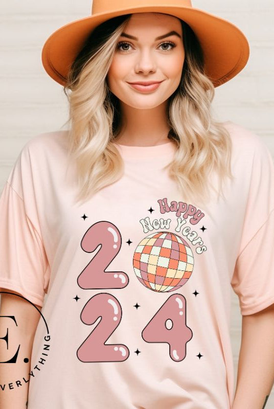 Step into the new year in dazzling style with our 'Happy New Year 2024' shirt. Featuring a shimmering disco ball as the '0' this eye catching design exudes festivity and fun on a peach shirt. 