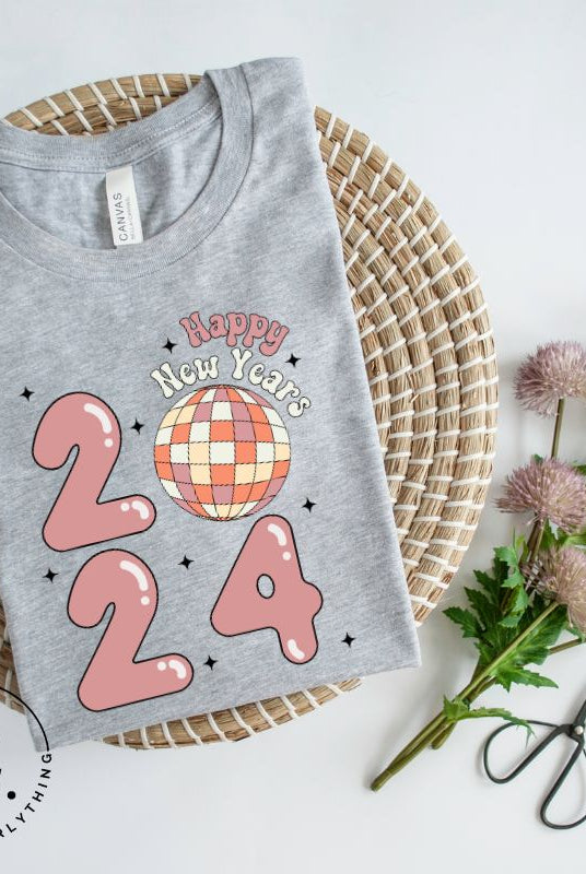 Step into the new year in dazzling style with our 'Happy New Year 2024' shirt. Featuring a shimmering disco ball as the '0' this eye catching design exudes festivity and fun on a grey shirt. 