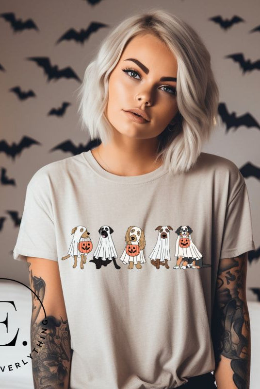 Are you excited for Halloween? Our t-shirt featuring five adorable dogs dressed as ghosts and going trick-or-treating is the perfect way to get into the festive spirit! Whether you're a dog lover or a Halloween enthusiast, on a grey shirt. 