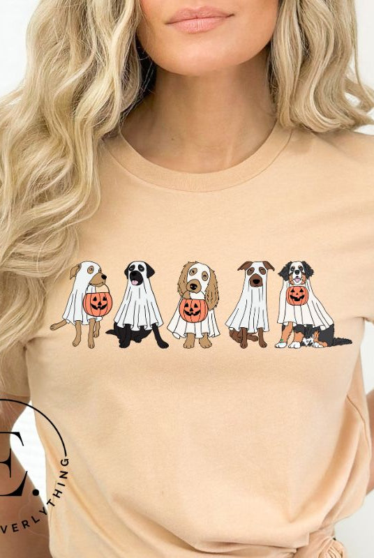 Are you excited for Halloween? Our t-shirt featuring five adorable dogs dressed as ghosts and going trick-or-treating is the perfect way to get into the festive spirit! Whether you're a dog lover or a Halloween enthusiast, on a cream colored shirt. 