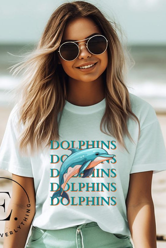 Introducing the Bella Canvas 3001 unisex graphic t-shirt that will make a splash! Dive into style with our Dolphins Dolphins Dolphins Dolphins tee, featuring a playful illustration of a dolphin for the Miami Dolphins football team on a ice blue shirt. 