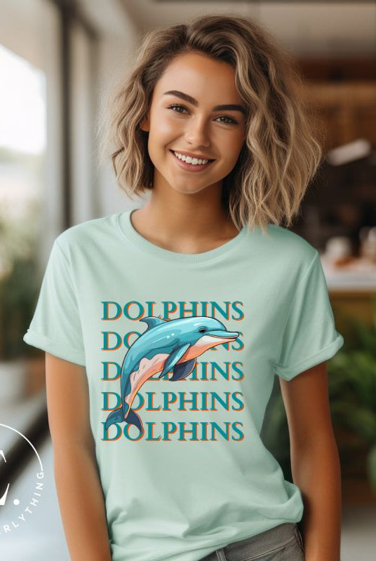 Introducing the Bella Canvas 3001 unisex graphic t-shirt that will make a splash! Dive into style with our Dolphins Dolphins Dolphins Dolphins tee, featuring a playful illustration of a dolphin for the Miami Dolphins football team on a mint colored shirt. 