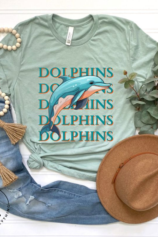 Introducing the Bella Canvas 3001 unisex graphic t-shirt that will make a splash! Dive into style with our Dolphins Dolphins Dolphins Dolphins tee, featuring a playful illustration of a dolphin for the Miami Dolphins football team on a mint shirt. 