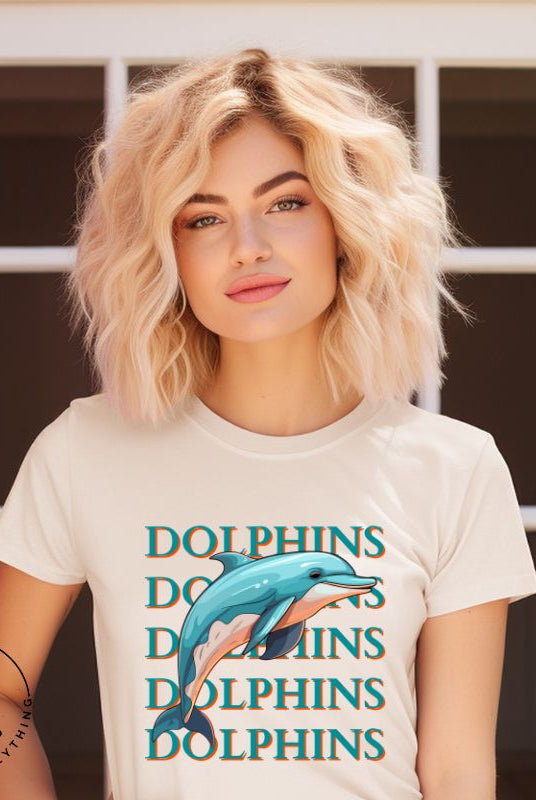 Introducing the Bella Canvas 3001 unisex graphic t-shirt that will make a splash! Dive into style with our Dolphins Dolphins Dolphins Dolphins tee, featuring a playful illustration of a dolphin for the Miami Dolphins football team on a soft cream shirt. 