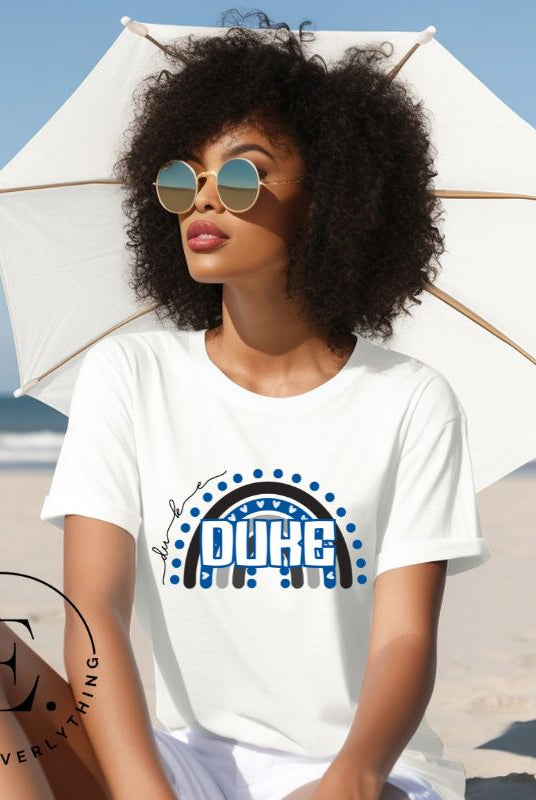 Celebrate diversity and show your support for Duke University with our eye-catching college t-shirt. Our shirt features the Duke colors on a captivating rainbow design, embodying the spirit of inclusion and unity with the iconic Duke wordmark atop the rainbow on a white shirt. 