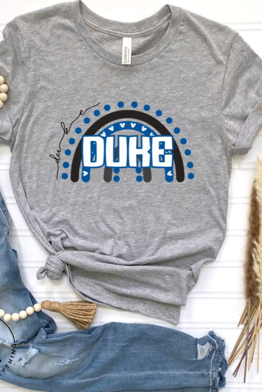 Celebrate diversity and show your support for Duke University with our eye-catching college t-shirt. Our shirt features the Duke colors on a captivating rainbow design, embodying the spirit of inclusion and unity with the iconic Duke wordmark atop the rainbow on a grey shirt. 