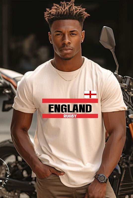Introducing our England Rugby Graphic T-Shirt - made for rugby fans who want to show off their pride in a stylish and contemporary way! Featuring the words "England Rugby" and the iconic England flag,  on a heather dust colored shirt. 