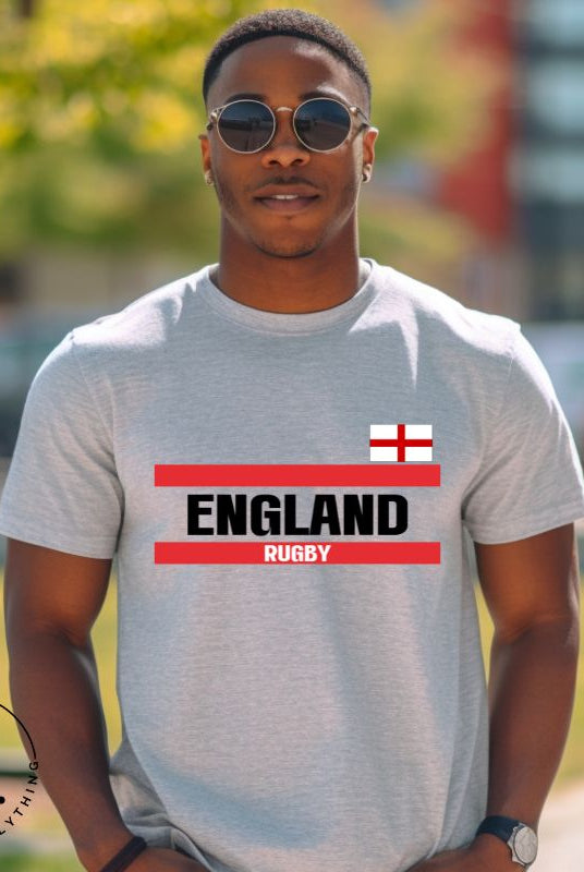 Introducing our England Rugby Graphic T-Shirt - made for rugby fans who want to show off their pride in a stylish and contemporary way! Featuring the words "England Rugby" and the iconic England flag,  on an athletic heather grey shirt. 